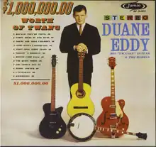 Photo of the artist stood behind three stood-up guitars and one banjo lying down. His name, the album title, the track list, and the record label's logo are printed around him.