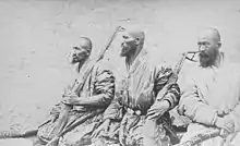 Photo of three bearded, armed men