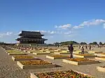 Birds eye view of a palace with several large structures surrounded by a rectangular corridor.