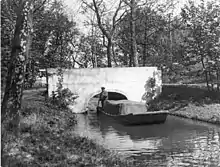 Photo of a man on a punt at Oare Gunpowder Works in 1900