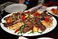 Mixed Arabic meat platter served on a bed of rice, in a restaurant in the United Kingdom