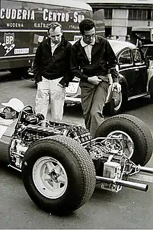 John Surtees and Mauro Forghieri inspect the flat-12 engine in a 1964 Ferrari 1512