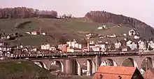 Push-pull set with motor coach in green and cream livery on the Glatttal viaduct (Herisau)