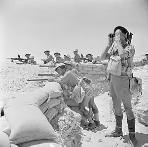 British soldiers in khaki drill uniforms, including shorts, in the Western Desert in 1942.