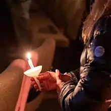 Candles held during Candlelight Christmas service