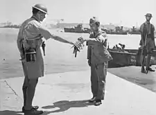 Image 5630 August 1945. Yokosuka Naval Base, Tokyo Bay. Commander Yuzo Tanno hands over the keys of Yokosuka Naval Base to Captain H. J. Buchanan, Royal Australian Navy. Buchanan led the first Commonwealth party to go ashore in Japan. (from History of the Royal Australian Navy)