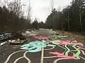 Looking south at the abandoned section of the Champlain Parkway with a makeshift skate park and graffiti