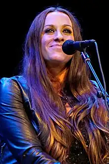 Alanis Morissette playing guitar