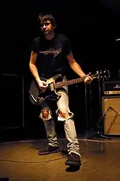 Recording engineer Steve Albini holding a guitar