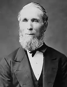 Monochrome photograph of Alexander Mackenzie sitting in a chair.