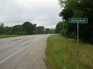 Alleyton road sign on FM 102 looking north