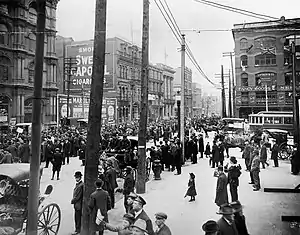 Masses of people on big-city street.