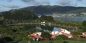 View of Aotea Lagoon, North Island, New Zealand from the north-east. Royal New Zealand Police College chalets in the foreground with Pipitea miniature railway station across the lagoon.