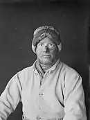 Monochrome portrait photograph of Apsley Cherry-Garrard in artic explorer's woollen clothing with sunburnt nose and goggle-marks