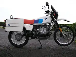  Black BMW R 80 G/S pictured on gravel at the edge of a lake