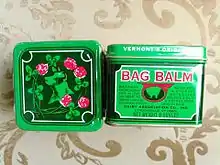 metal container of bag balm shown in top and side view