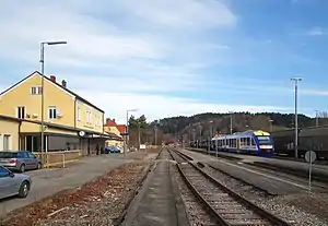 Two-story building in front of yard tracks