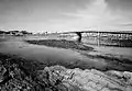 View of the bridge from the rocky shoreline;