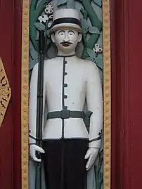 Contemporary soldier dvarapala as doorkeeper at Wat Ratchabophit, Bangkok