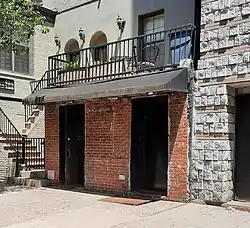 Photograph of an entrance to a building on a city street on a sunny day