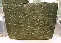 Possible prisoners and wounded men of the Buto-Maadi culture devoured by animals, while one is led by a man in long dress, probably an Egyptian official (fragment, top right corner). Battlefield Palette.