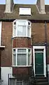 Brick coloured mathematical tiles on a bay window in George Street Location on Google Maps