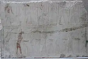 Relief showing two rows of people with hieroglyphic signs