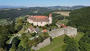 A medieval castle with a tower surrounded by a wall