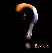 A shaved human head lit from behind to only show the back, creating the shape of a question mark, with their ear faintly visible. The band name is in the bottom-right corner.