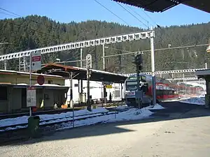 Red-and-white train arrives at platform