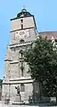 Statue of Johannes Honter in front of the bell tower