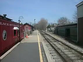 A Black River and Western caboose, semaphore, and station depot at the station in Ringoes