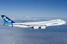 Side view of quadjet over clouds