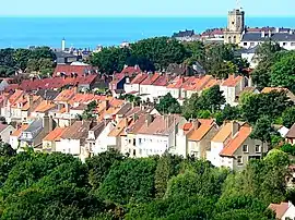 A general view from the Brecquerecque Quarter:The modern lighthouse, the medieval bell tower and the English Channel