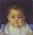 Head and shoulders portrait of an infant boy wearing a white bib