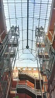 The building's distinctive open elevator shafts and large glass skylight