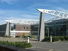 A picture of a two-storey building with two free-standing masonry piers on front