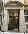 Entrance of the bank's former Brussels office with inscription "Banque Congo Belge" and ironwork displaying the Congo Star