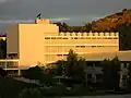 Eastern face of Building 9 with the 'CPP' hill visible in the distance