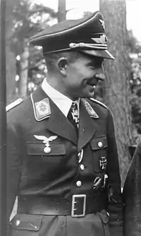 A man wearing a military uniform with an Iron Cross displayed at the front of his uniform collar.