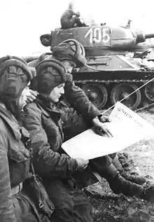 Image 18Soldiers in an East German tank unit reading about the erection of the Berlin Wall in 1961 in Neues Deutschland (from Newspaper)