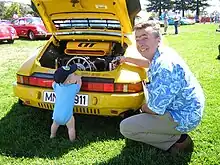 A view of the  Ruf CTR engine bay of the CTR with Alois Ruf present near the car