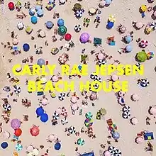 An overhead photo of a crowd of beachgoers and multicolored umbrellas