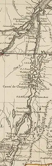 The map is oriented with north to the top. The lower section of the map shows Saratoga, New York, and Fort Edward, on the Hudson River. There are red markers depicting the position of John Burgoyne's army near Saratoga at the time of its surrender in 1777. A line of mountains is shown to the right of the Hudson, extending northward but eventually bending off the map to the east. North of Fort Edward are Fort George, at the southern end of Lake George, and Skenesborough, near the southern end of Lake Champlain. About one-third of the way up the map, Lake George joins with Champlain, and Fort Ticonderoga is shown at the northwest side of the junction, with Fort Crown Point a little further north. Lake Champlain extends to the north and is dotted with islands. There is a red line marking the boundary between New York and Quebec, and the upper third of the map shows the Richelieu River extending north to meet the Saint Lawrence River at Sorel, with Montreal southwest of that point. Fort Saint John and Fort Chambly are to the left of the Richelieu, about halfway between the boundary line and Montreal.