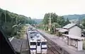 The station in 1996, when it had two platforms and two tracks. Note the old station building.