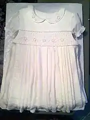 A cake decorated to resemble a child's dress