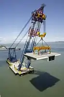 Left Coast Lifter raises a prefabricated steel bridge segment for the new eastern span of the Bay Bridge.