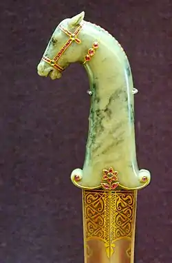 Mughal dagger with hilt in jade, gold, rubies and emeralds. Blade of damascened steel inlaid with gold.