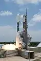 A Delta II rocket ignites its engines, including 9 GEM 46 solid rockets.