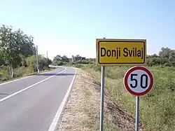 Donji Svilaj village sign. On both sides of the road at the Donji Svilaj eastern boundary are ruins of Miletić family houses, all destroyed in Yugoslav war.